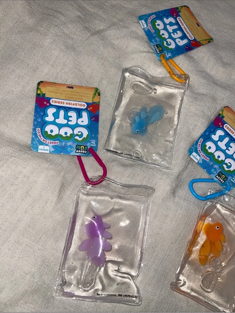 Goo Pets Squishy Goldfish Keychain Pack — Blue, Pink, Orange, Purple